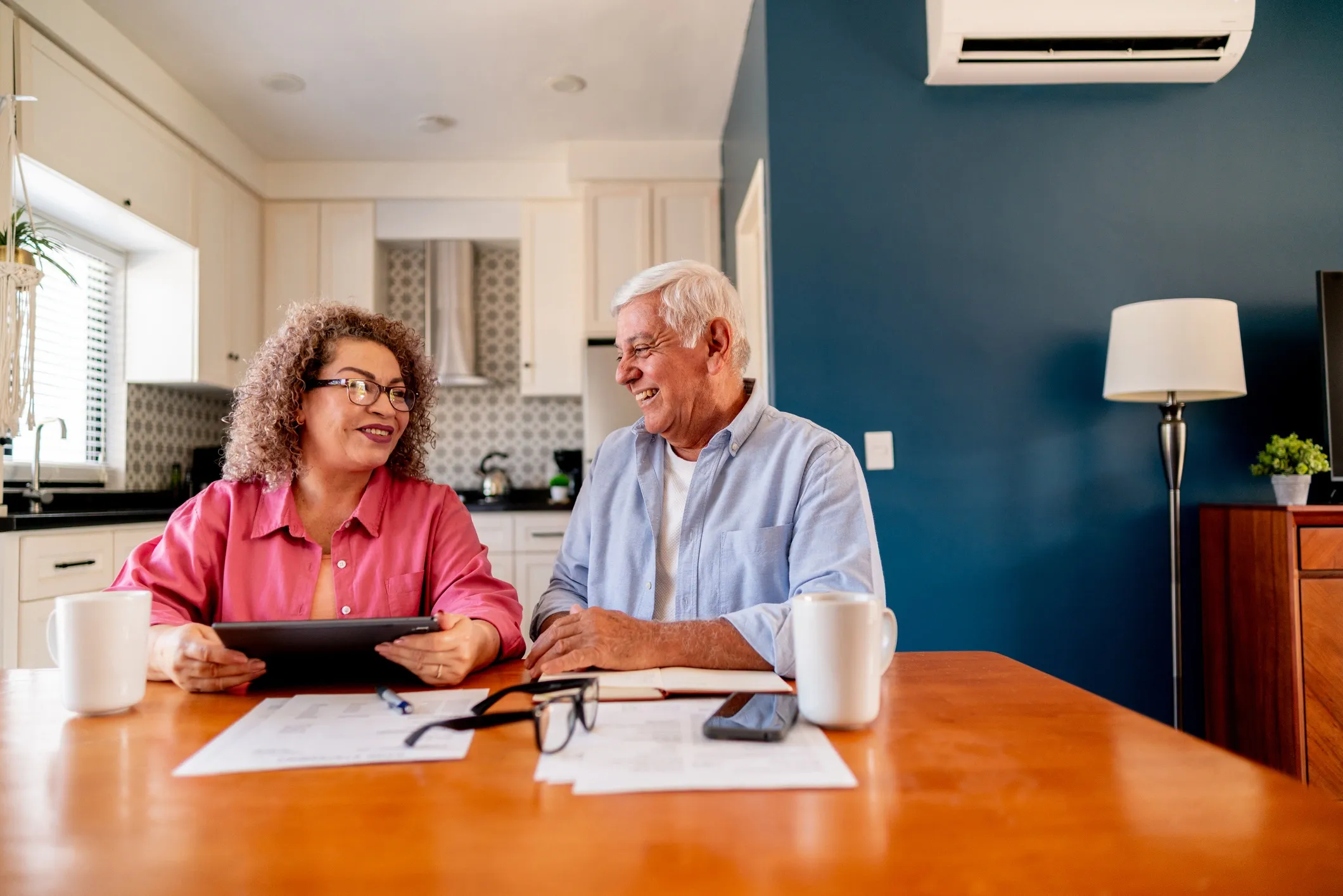 Older couple discussing finances at home.